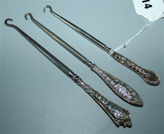 3 Victorian silver handled button hooks(-)